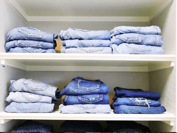 color coded jeans in a closet