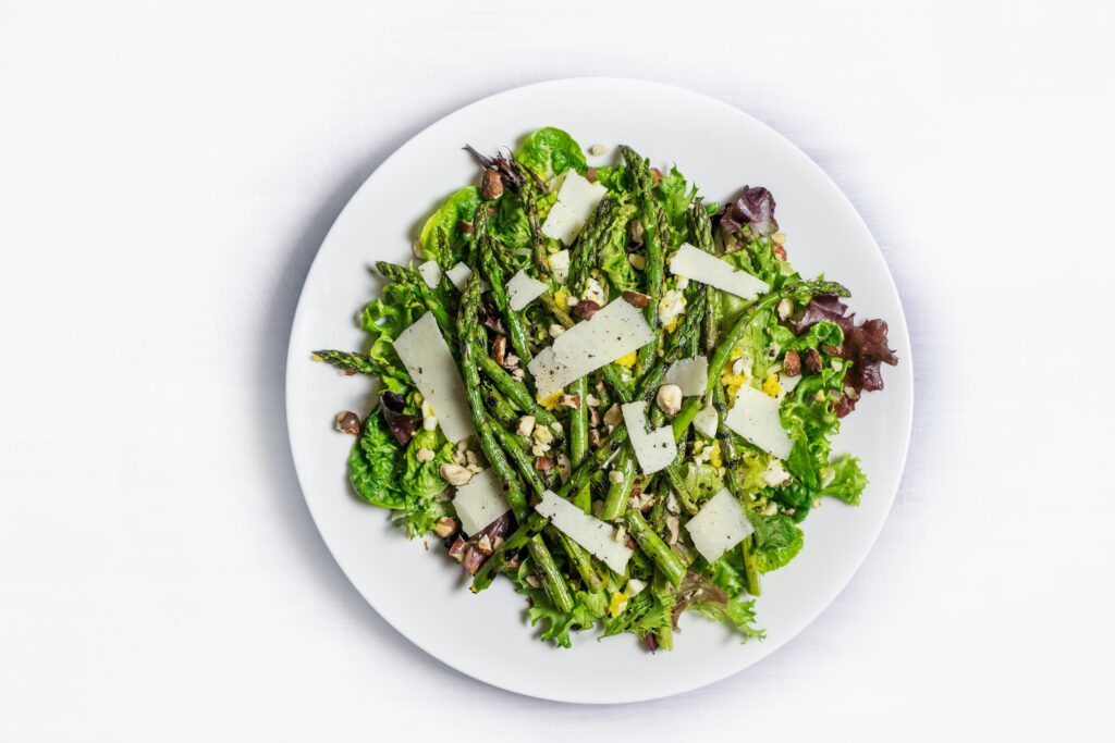a plate full of fresh greens in a salad