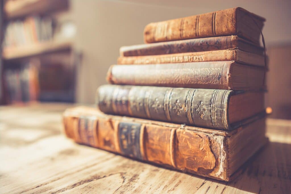a stack of old leather bound books