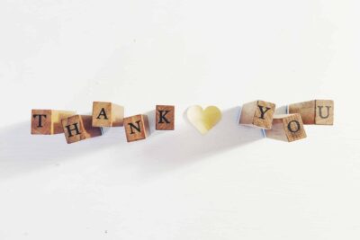 thank you written out on wooden blocks with a heart in the middle