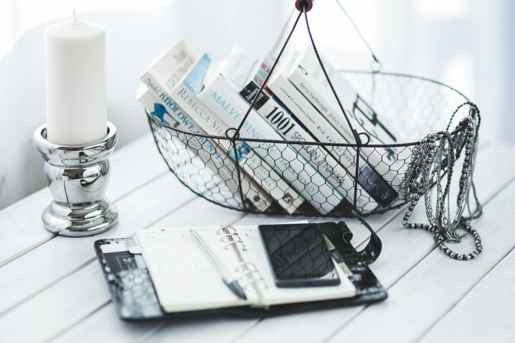a minimalist basket with books and a candle